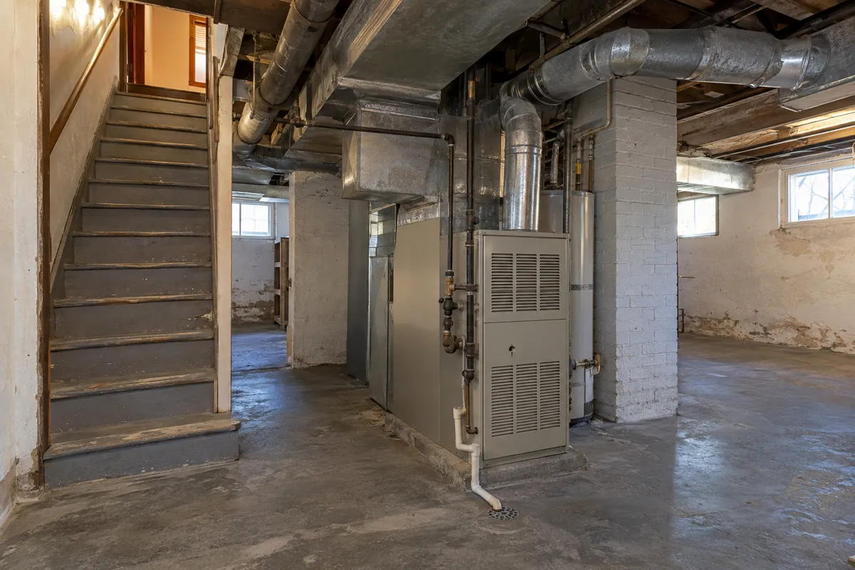 Unfinished basement with stairs, ductwork and a furnace, ductless mini-split systems in Memphis, TN