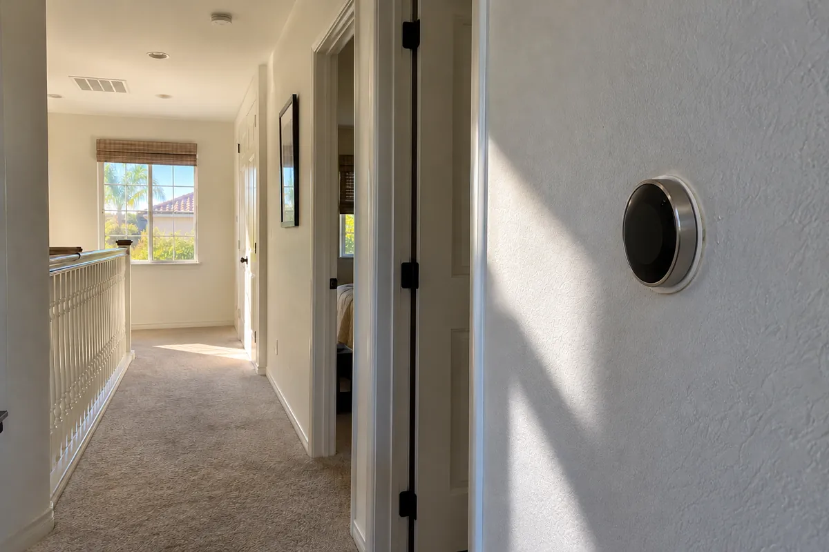 Round smart thermostat on an upstairs hallway wall, thermostat installation in Memphis, TN